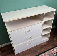 Front view of dresser showing three drawers and open shelving