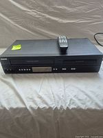 Front view of Philips DVP3345VB/F combo with remote on top