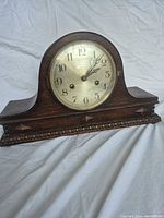 Front view of Richardson Leicester wooden mantel clock showing full case and dial
