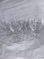 Front view of six goblets showing cut pattern and clarity