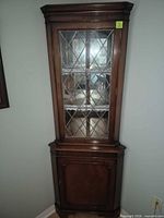 Full front view of corner china cabinet closed
