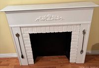 Front view of mantel surround showing overall design, brick interior and hanging tools