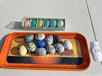 Tray with 11 loose alabaster eggs and boxed set of 8 mini eggs