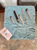 Five glass bottles laid on blue cloth