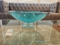 Overall view of turquoise glass bowl on clear glass pedestal