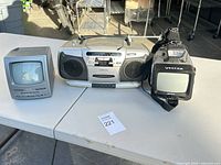 Front view showing mini TV, Emerson boombox, Vector spotlight