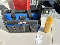 Front view of Kobalt tool tote and sealed yellow water bottle