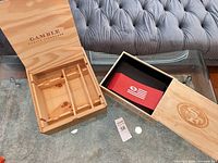 Both wooden wine boxes open on table showing interiors and branding