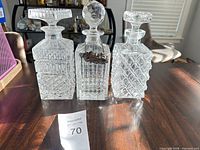 All three decanters with stoppers on tabletop