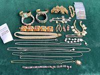 overview of entire jewellery lot on green background