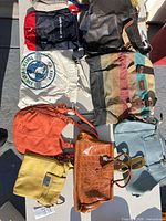 Overview showing ten assorted bags on table