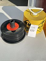 Stack of 45 RPM records beside yellow KOME 98.5 case