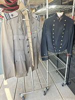 Both jackets hanging on rack