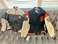 Both jackets laid out on couch showing overall design and colors