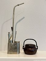 Full view of paktong water pipe and incense burner side by side