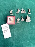 Group view of all pewter miniatures and brooch