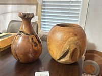 Front view of both wooden vessels on table