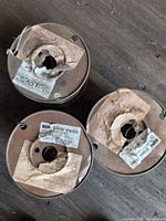 Top view three wire spools with worn labels