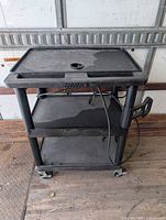 Full view of three-shelf Luxor AV cart on casters