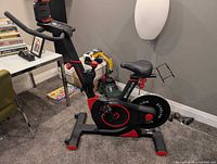 Full view of Echelon exercise bike showing frame, seat, handlebars, tablet mount, flywheel