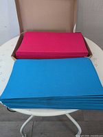 Open box showing stacks of magenta and blue legal file folders