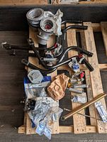 Pallet with hub caps, latch rods, springs, gladhands, hardware