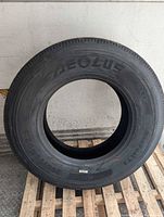 Full view of Aeolus truck tire resting on pallet