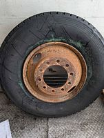 Full view of tire on rusted steel wheel