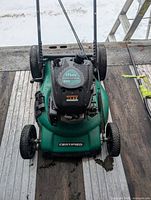 Top view of green Certified push lawn mower with 174 cc engine