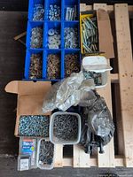 Overall view of lot showing trays, tubs, box and packaged fasteners