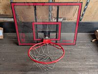 Front view of Spalding clear backboard with rim and chain net
