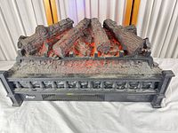 Front view of electric fireplace log insert with glowing LED embers