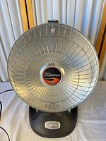 Full front view of Presto HeatDish heater showing parabolic reflector, base and power cord