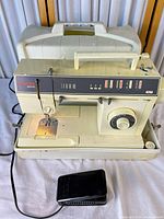 Full view of Singer Merritt 8220C with foot pedal and carrying case