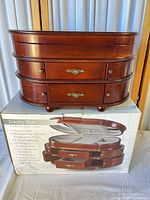 Closed jewelry box on original carton showing exterior finish and hardware