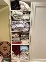 Shelf with multiple folded linens in various colors