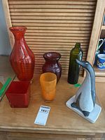 Group shot of all five vases and penguin