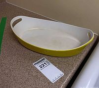 Full view of yellow Copco oval enameled dish on countertop