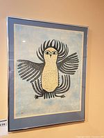 Full view of framed owl print on wall
