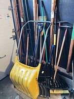 group of snow scoop, rakes, shovels and broom