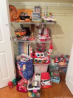 Overall view of shelves and bins containing assorted holiday decorations and gift-wrap supplies