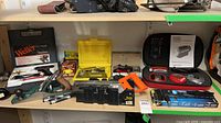 Shelf with entire lot showing soldering gun kit, hand plane, miter boxes, staple gun, laser level kit