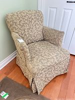 Front view of upholstered chair with slipcover