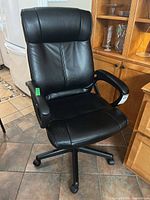 Front angled view of black faux leather office chair