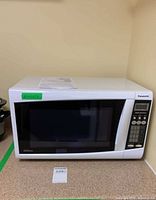 Front view of white Panasonic microwave oven on countertop