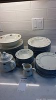 Stacked plates, bowls, teapot, creamer
