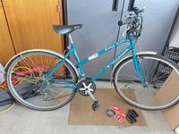 Full view of Triumph City Lite bicycle with accessories on floor