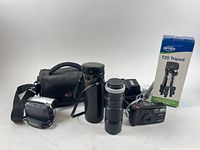 Group view of camcorder, Canon lens with case, Pentax camera, camera bag, tripod box, charger