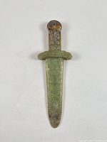 Full view carved jade dagger pendant front