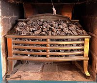 Full view of cast iron electric insert in fireplace opening